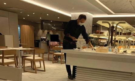 Christo Grozev wearing a mask at a hotel breakfast bar