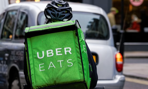 An Uber Eats courier drives through London.