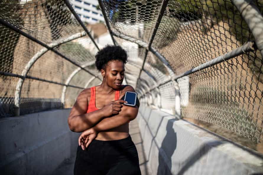 Running apps can be very motivating (posed by model).