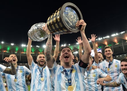 Lionel Messi lifts the Copa América trophy as he celebrates with team-mates after Argentina’s victory over Brazil.