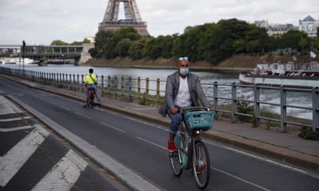 Parisians ride their bikes along the Seine river in Paris, Sunday, 24 May 2020, as France gradually lifts its lockdown.