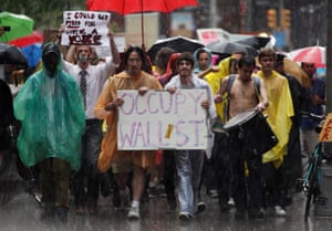 Demonstrators from the Occupy Wall Street campaign march in the rain through the streets of the financial district of New York on 29 September 2011.