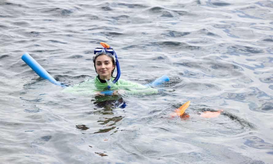 Guardian Australia journalist Rafqa Touma kitted out with a pool noodle and flippers, in the water during her first attempt at snorkelling.