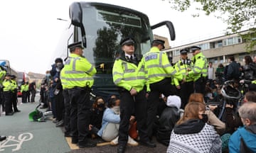 Police and protesters in front of the coach at the Best Western hotel in Peckham.