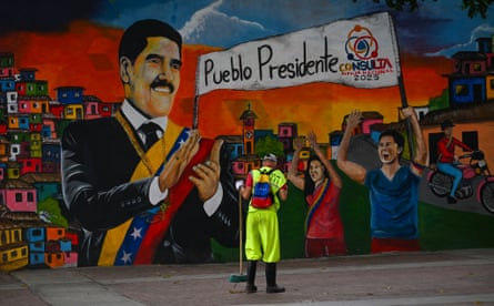 a cleaner stands in front of a mural