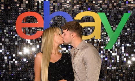 Love Island’s Tasha Ghouri and Andrew Le Page kiss in frnot of an eBay logo at a ‘pre-loved sparkle’ event in November.