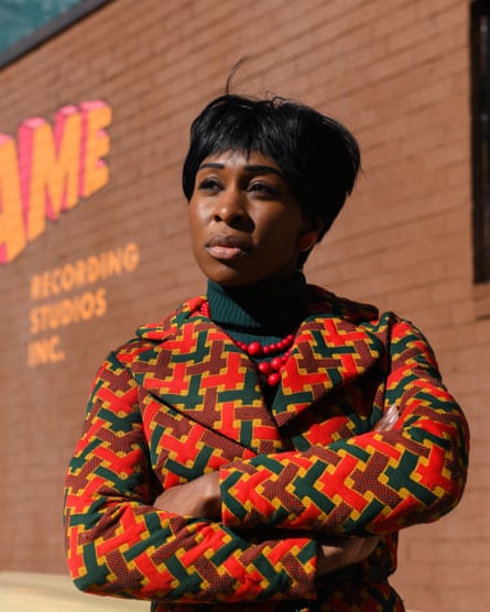 Erivo in 60s style as Aretha Franklin outside a recording studio.