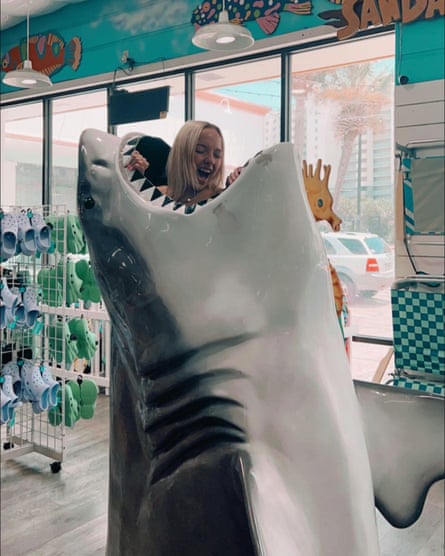 Addison posing inside a fibreglass shark in a shop – she likes to joke about the creature.