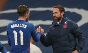 Jack Grealish shakes hands with Gareth Southgate after being substituted.