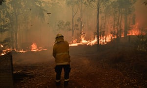 Firefighters protect a home being impacted by the Gospers Mountain fire near Colo Heights, Sydney, this week.