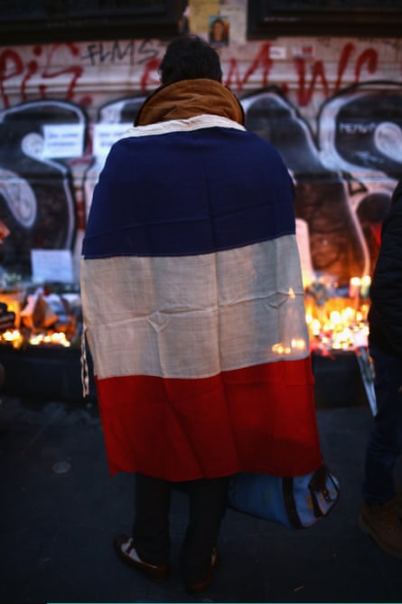 Parisians light candles and lay tributes on the monument at the Place de la République.