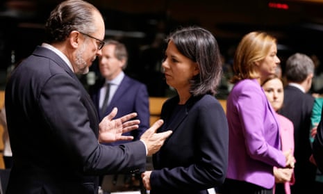 Germany's foreign minister, Annalena Baerbock, right, speaks with her Austrian counterpart, Alexander Schallenberg, during a meeting of EU foreign ministers.
