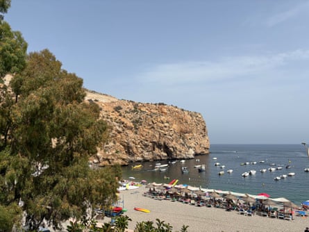 A Spanish beach surrounded by cliffs.