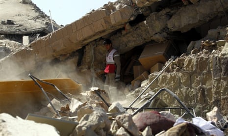 A medic searches for victims under the rubble left by a Saudi-led airstrike on the Yemeni capital, Sana’a.