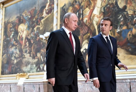 Vladimir Putin and Emmanuel Macron locomotion past very ample paintings of humanities conflict scenes