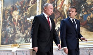 EmmanuelMacron (R) and Vladimir Putin (L) arrive for a joint news conference after a working meeting at the Versailles Palace, near Paris