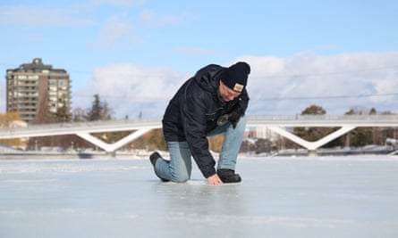 Bruce Devine checks the ice condition on the Rideau Canal Skateway on 8 February. This winter has brought wild and unseasonably warm weather to Canada’s capital.
