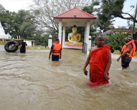 A Sri Lankan Buddhist monk stands near a flooded temple in a suburb of Colombo