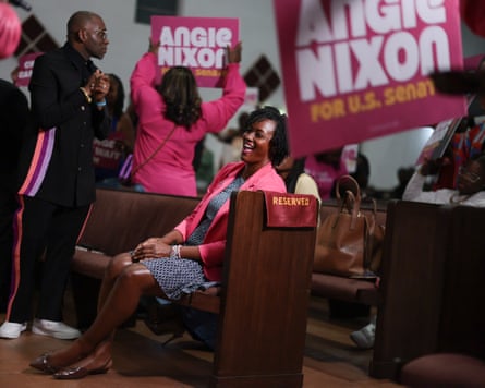 Angie Nixon wears a pink suit
