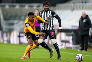 Nelson Semedo of Wolverhampton Wanderers tussles with Allan Saint-Maximin of Newcastle United.