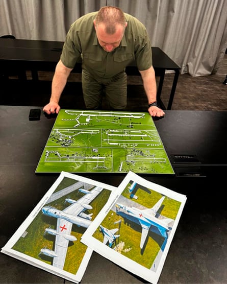 Malyuk studies a map of Russia’s strategic aviation location and photos of military aircraft