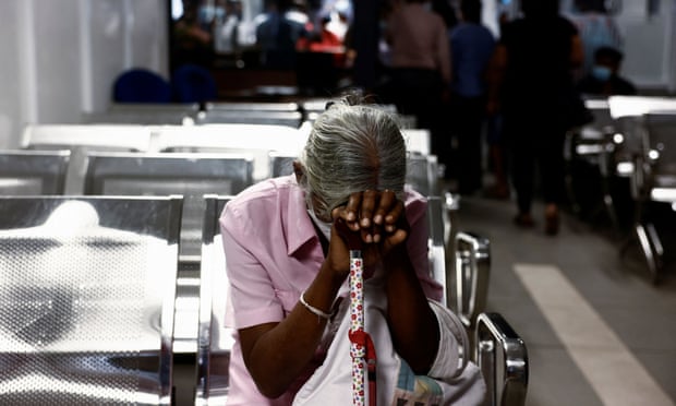 A woman waits to apply for a passport at the Sri Lanka’s Immigration and Emigration Department