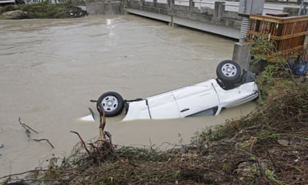 A pickup truck rests against the side of Gills Creek near a bridge in Columbia, South Carolina, on Monday.
