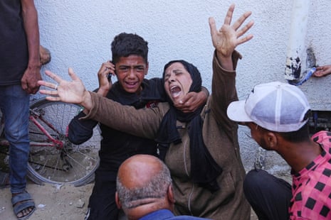A Palestinian woman mourns over the body of her child killed in an Israeli military strike on Gaza, at Al-Shifa Hospital in Gaza City.