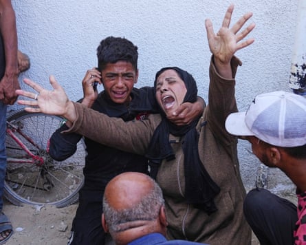 A Palestinian woman mourns over the body of her child killed in an Israeli military strike on Gaza, at Al-Shifa Hospital in Gaza City, Thursday, June 19, 2025.