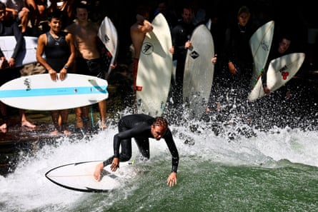 A surfer rides the Eisbach wave during summer 2024.