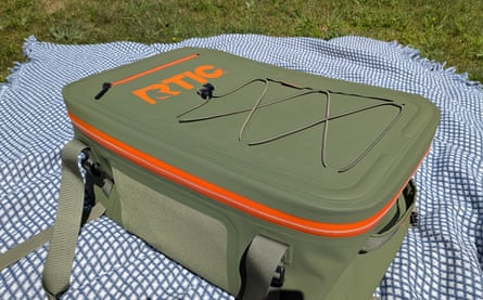 green cooler on blanket in grass