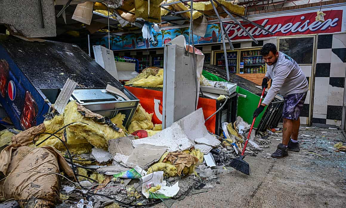 A man sweeps up debris