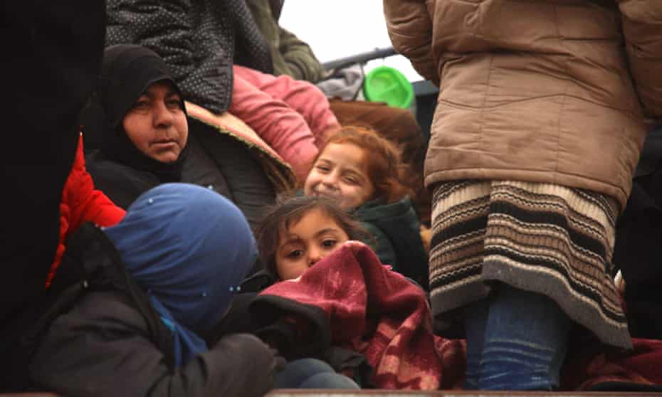 Women and children in the back of a truck near al-Ghazawiya, in Syria.