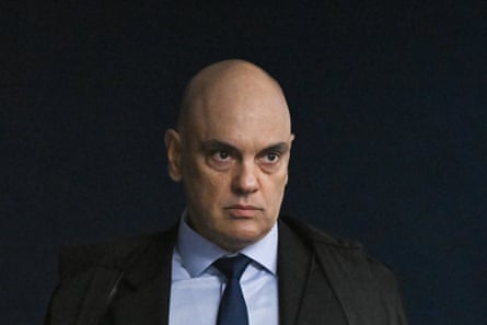a man in a suit looks off to the side