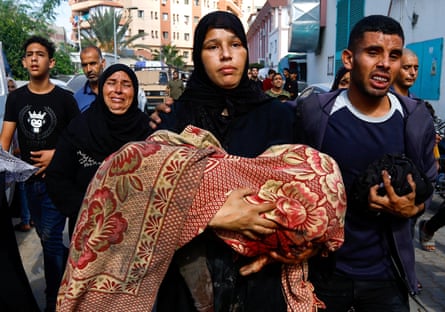 Farid and Qoosay’s mother holding the body of one of her children, killed during an Israeli airstrike on their house.