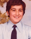 Wearing a shirt and tie, aged about 12, he smiles for a photo