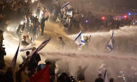 Israeli police use a water cannon to disperse demonstrators during a protest in Tel Aviv