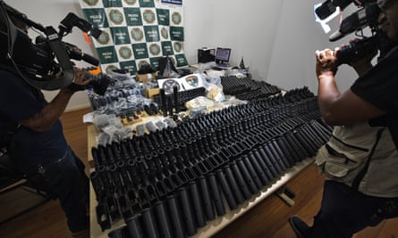 Automatic weapons, money and other equipments seized at the house of a friend of Ronnie Lessa.