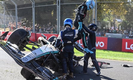 George Russell is helped from his crashed Mercedes