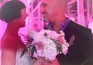 Anna holds her bouquet made up of flowers and marijuana leaves