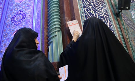 Two women cast their votes in Iran’s parliamentary elections on Friday.