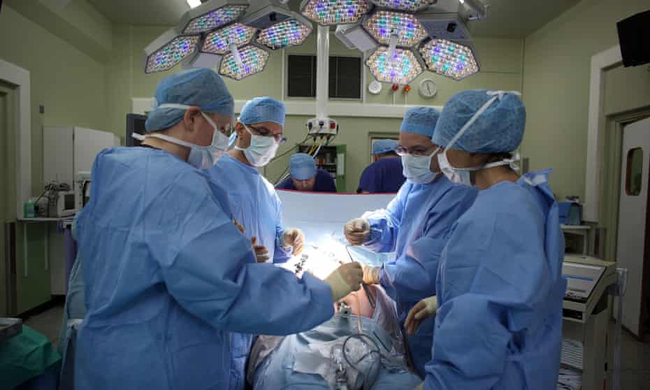 A surgeon and his theatre team performing keyhole surgery.
