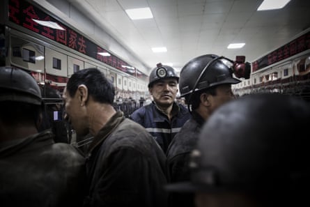 Miners stand in a locker room at a coal mine and processing facility in Liulin, Shanxi province, China.