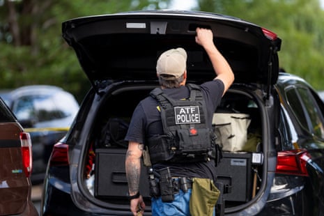 An officer with the ATF opens his trunk while setting up outside the shooting at Annunciation Church, which is also home to a an elementary school, in Minneapolis, Minnesota, U.S. August 27, 2025.