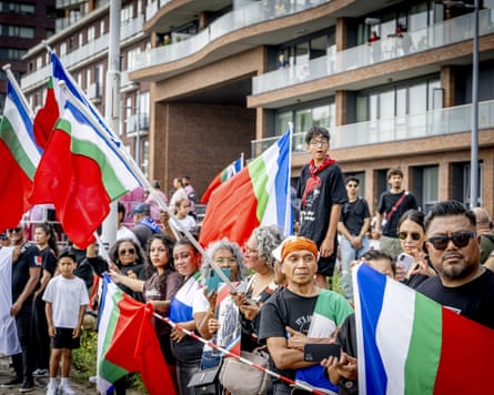 People in the crowd waving flags