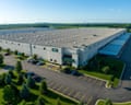 aerial shot of a warehouse surrounded by trees