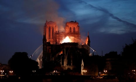 Firefighters douse flames of the burning Notre Dame Cathedral in Paris.