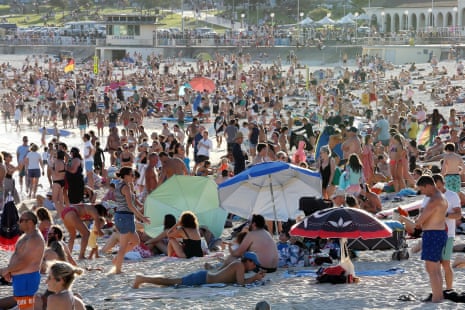 Beachgoers are seen at Bondi beach in defiance of social distancing rules banning gatherings of more than 500 people and mandating 1.5m between individuals in public areas.