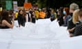 People carry a petition including the names of victims of domestic violence during a March 4 Justice rally against sexual violence and gender inequality in Melbourne in February 2022