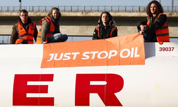 Just Stop Oil activists sit on top of a fuel tanker during a protest in Grays, Essex, 15 April 2022. 